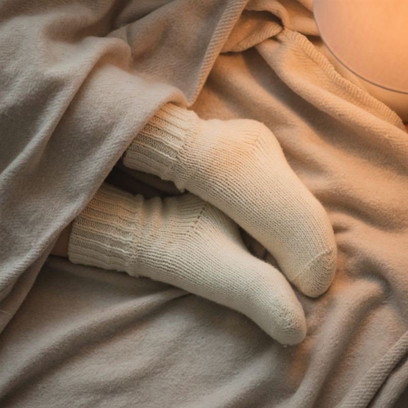 Feet in cozy knitted socks for a covered feet pic set